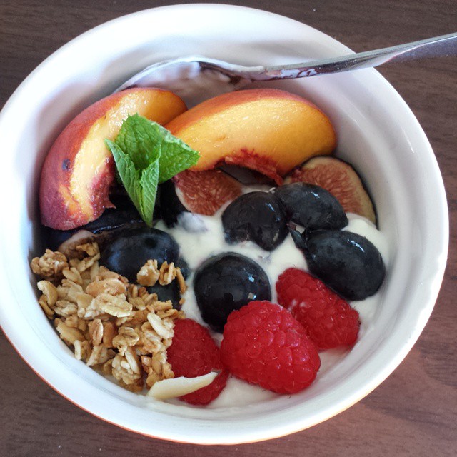 Liberte coconut yogurt, raspberries, concord grapes, peaches, figs and a sprig of minty goodness.